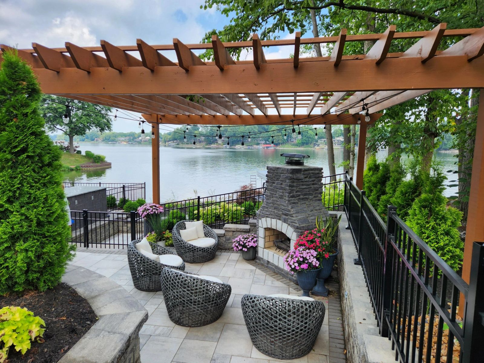 Pergola and outdoor fireplace overlooking the lake